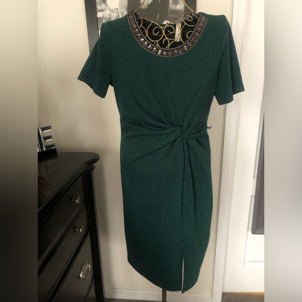 Green short sleeve dress with embellished neckline and ruching at the waist.